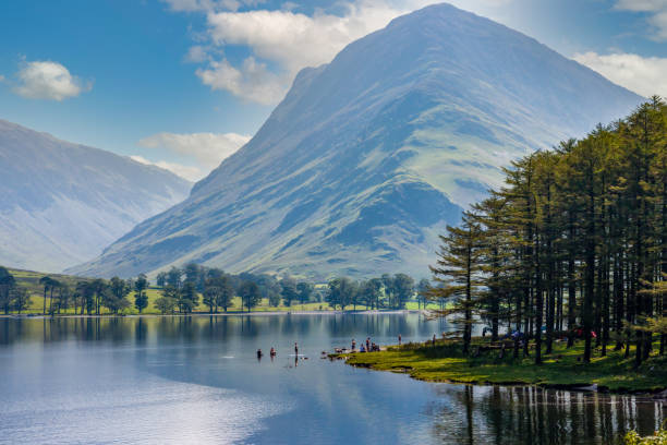 Beautiful lake surrounded by mountains Beautiful lake of Buttermere surrounded by green hill in England's Lake District calm water photos stock pictures, royalty-free photos & images