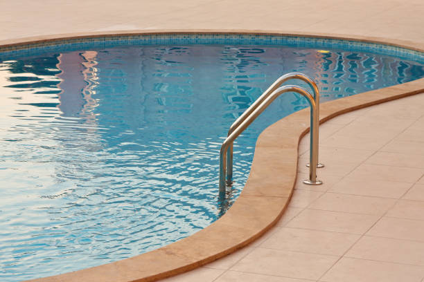 istock Swimming pool with metal ladder at the evening 1284596065