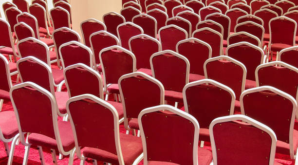 Empty conference room with red chairs in a row