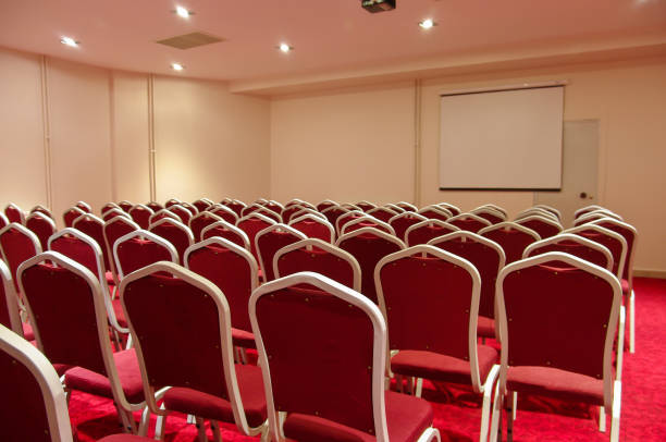 istock Conference room with red chairs in a row 1284596747