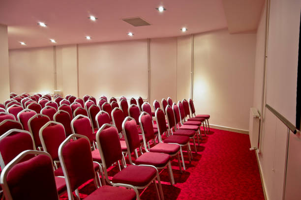istock Conference room with red chairs in a row 1284596761