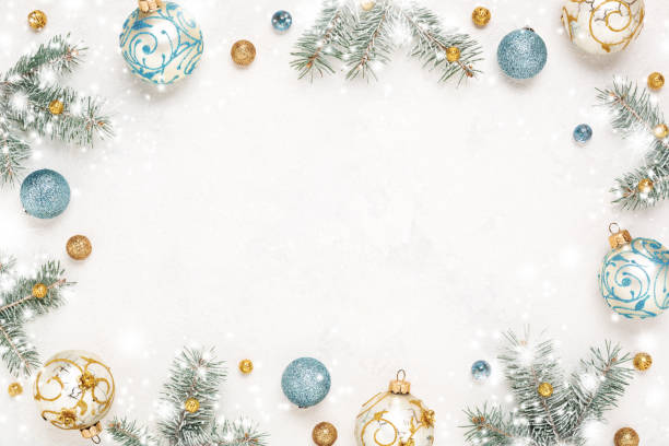 Christmas frame on snowy white background with gold blue decorations, copy space.