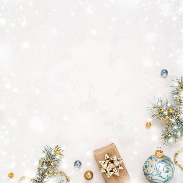 istock Christmas snowy white background, gift, twigs and gold blue decorations. 1284596872