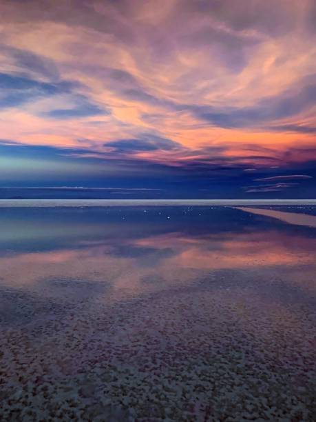 istock Magic romantic sunset heaven clouds reflection in the salt lake Salar de Uyuni, Bolivia, Surreal fantasy twilight in desert Atacama, Fantastic alien nature of planet Earth. 1284598047