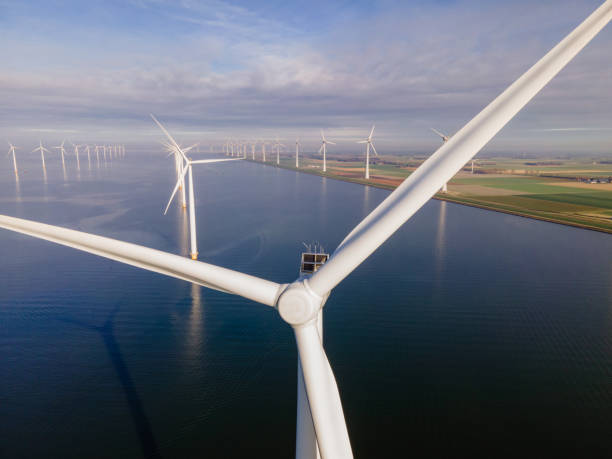 istock offshore windmill park with clouds and a blue sky, windmill park in the ocean drone aerial view with wind turbine 1284599514