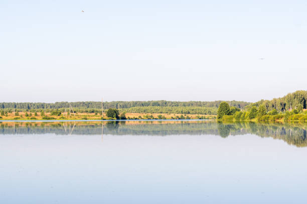 istock Lake at dawn, meadows and forests, a quiet windless morning. 1284600002