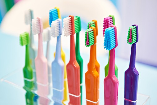 Colored toothbrushes on display in a store