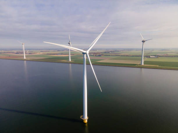 istock offshore windmill park with clouds and a blue sky, windmill park in the ocean drone aerial view with wind turbine 1284601132