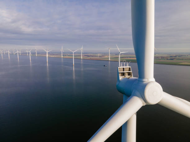 istock offshore windmill park with clouds and a blue sky, windmill park in the ocean drone aerial view with wind turbine 1284601242