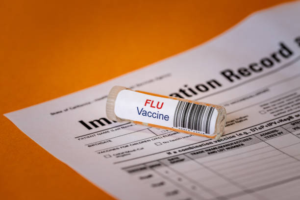 istock Glass Bottle with Flu Vaccine Label Attached 1284603732
