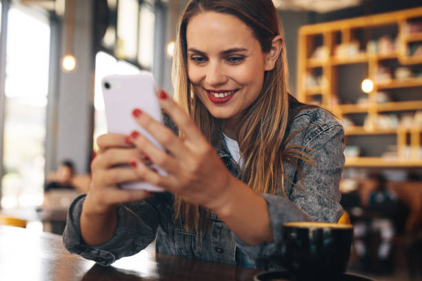 istock Woman texting on her mobile phone at cafe 1284603853