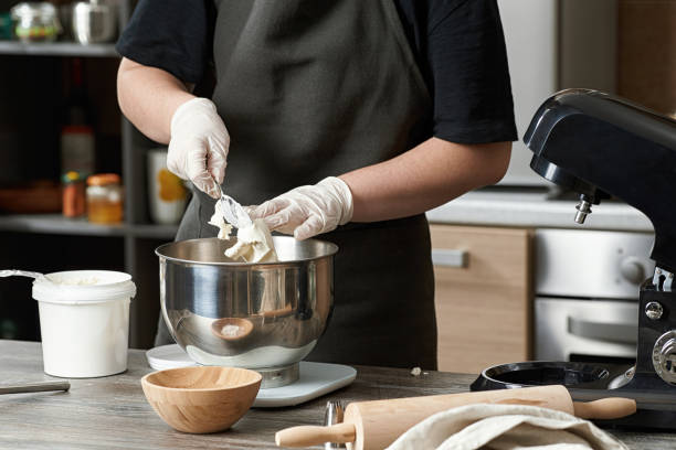 istock A pastry chef prepares a cream for a cupcake dessert. 1284604741