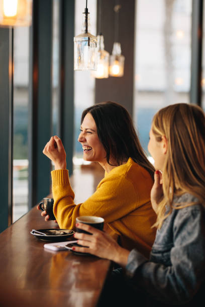 istock Women smiling in a coffee shop 1284604753