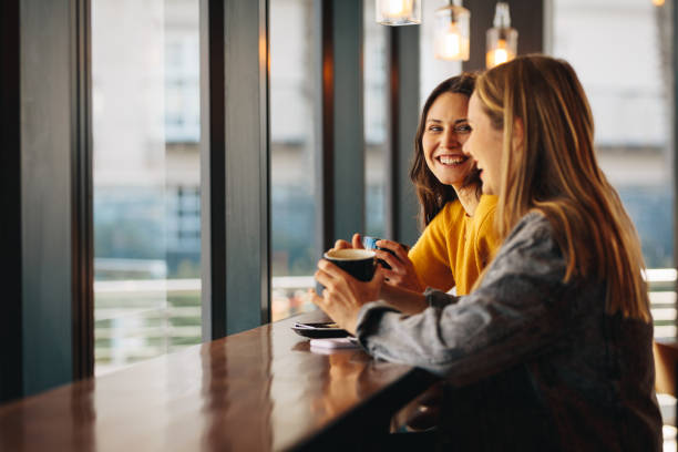 istock Friends gossiping in a coffee shop 1284605076