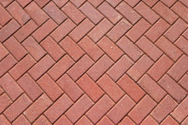 istock Abstract background from paving red tiles, bricks. Top view of the pavement pattern. Concept for construction, urban environment improvement, finishing works, landscape design 1284605977