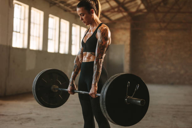 istock Strong woman exercising with heavy weights 1284607310