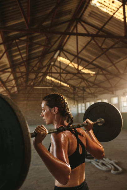 istock Woman doing squats workout in old warehouse 1284609023
