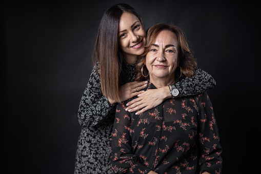 Studio shoot portrait of senior mother and daughter