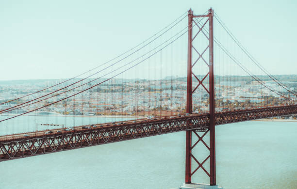 A suspension red rope bridge between Lisbon and Almada, Portugal named \