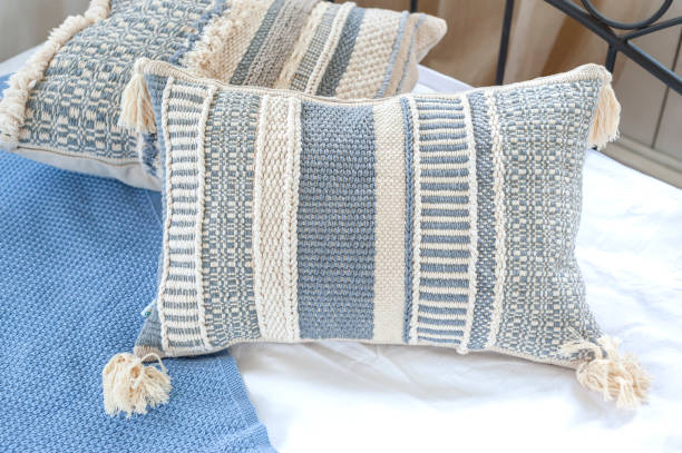 istock Handmade pillows on the bed covered with a blue blanket, close up 1284611455