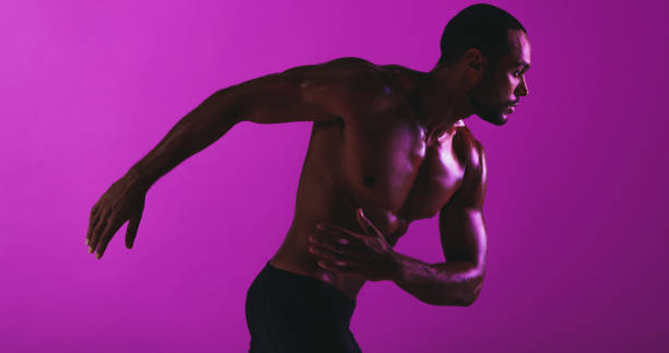 istock Fit athlete working out on purple background 1284612664