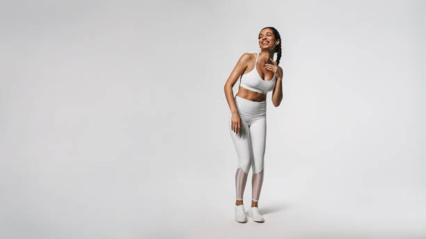 istock Smiling fit woman working out against white background 1284612728