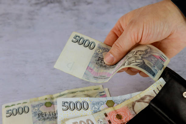 istock Man with hands of a Czech money on table 1284614199