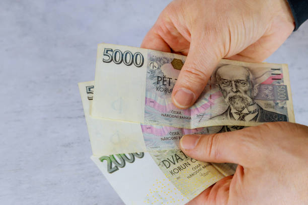 istock Hand of a man holding czech koruna banknote 1284614210