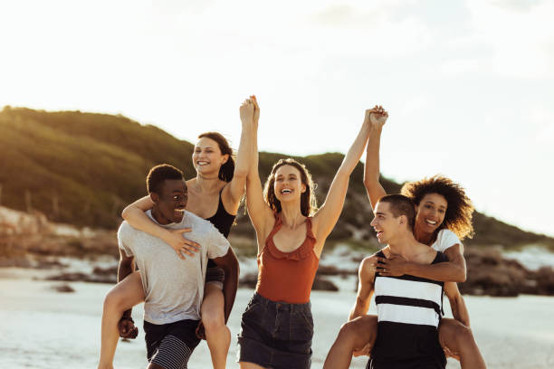 istock Group of young friends enjoying on beach 1284616630
