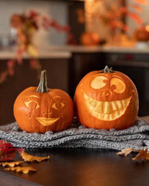 istock Two funny Halloween pumpkins on a table 1284618280