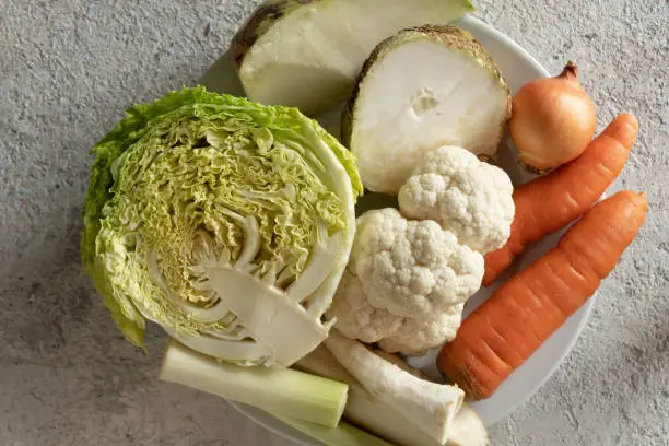 Photo of Carrots, celery root, onion and other Ingredients for preparing a vegetable broth or soup