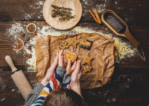 istock Mother with a child cooking a Christmas cookies on a table 1284619436