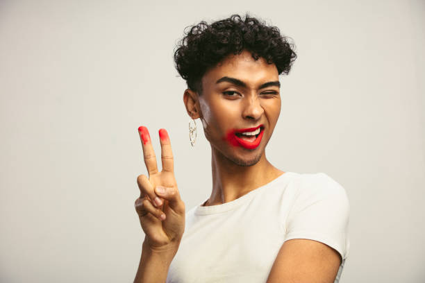 istock Gay man with smeared lipstick showing peace sign 1284620668
