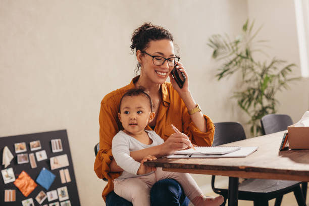 istock Working mom with child talking on phone 1284620848