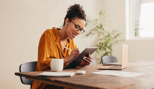istock Female designer at home sketching on a digital tablet 1284620947