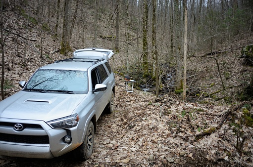 Blairsville, Georgia - March 18, 2020: Cooking lunch by creek with 4Runner parked near small creek in Chattahoochee National Forest near Blairsville, Georgia.  Car parked along W Wolf Creek Road.