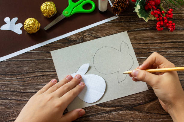 istock Instruction step 2. Funny Gift with candy Christmas deer on a wooden table. Handmade. Children's creativity project, crafts, crafts for kids. 1284622072