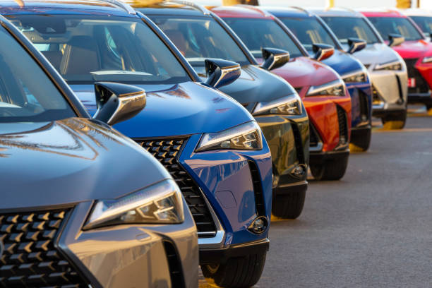 SUV cars on a parking Sitges, Spain - 26th February, 2019: Lexus UX (Toyota Group) SUV vehicles in hybrid version parked on public parking before the drives. The UX model is the smallest crossover in the Lexus offer. Focus on a second car. automobile industry stock pictures, royalty-free photos & images