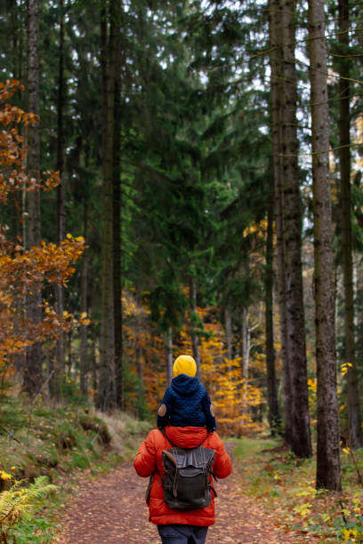 istock mother and son walk through the forest in autumn 1284623091