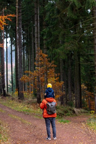 istock mother and son walk through the forest in autumn 1284623099