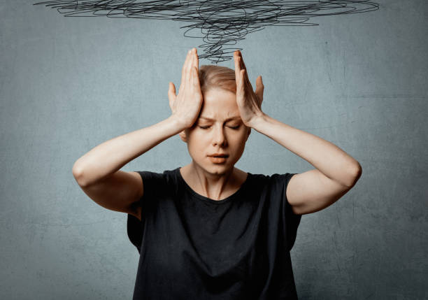 istock Woman with headache on grey background 1284623129