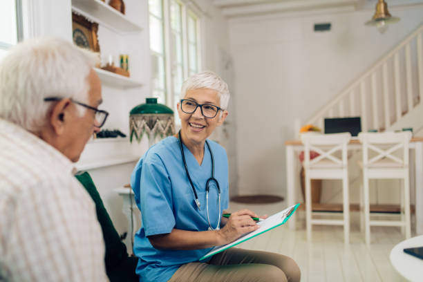 istock Mature doctor in a visit to her senior patient's home 1284626607