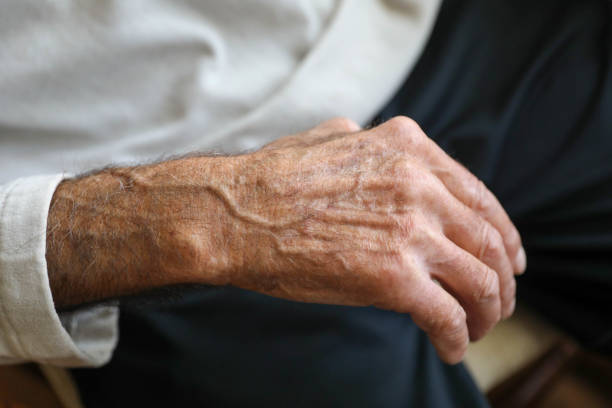 istock Close Up - detail wrinkled hands 1284627858