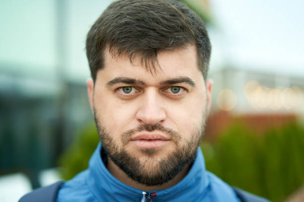 istock Young white bearded attractive man with serious look outdoor. 1284628838