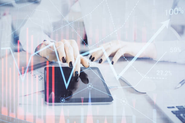 istock Double exposure of forex chart sketch hologram and woman holding and using a mobile device. Financial market concept. 1284629054