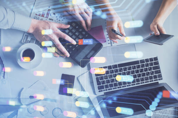 istock Double exposure of man and woman working together and data theme hologram drawing. Computer background. Top View. 1284629097