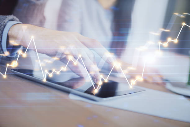 istock Double exposure of forex graph drawing and man and woman working together holding and using a mobile device. Trade concept. 1284629111