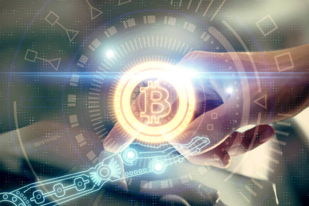 istock Double exposure of man's hands holding and using a phone and crypto currency blockchain theme drawing. 1284629151