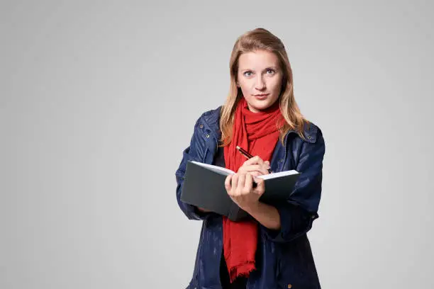 Young girl with notebook. Business woman write. Adorable caucasian businesswoman.