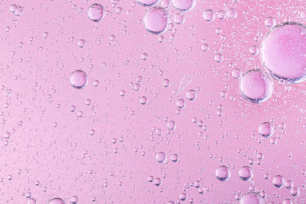 istock oil with bubbles on coral background. Pink Abstract space background. Soft selective focus. macro of oil drops on water surface. copy space. air bubbles in water 1284634724